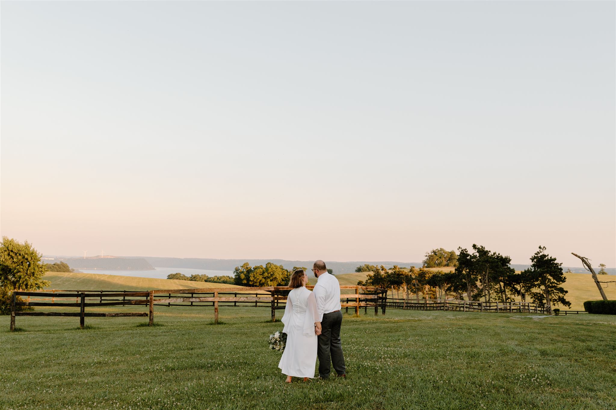 bride and groom on their wedding day looking out into the landscape at lauxmont farms in Pennsylvania