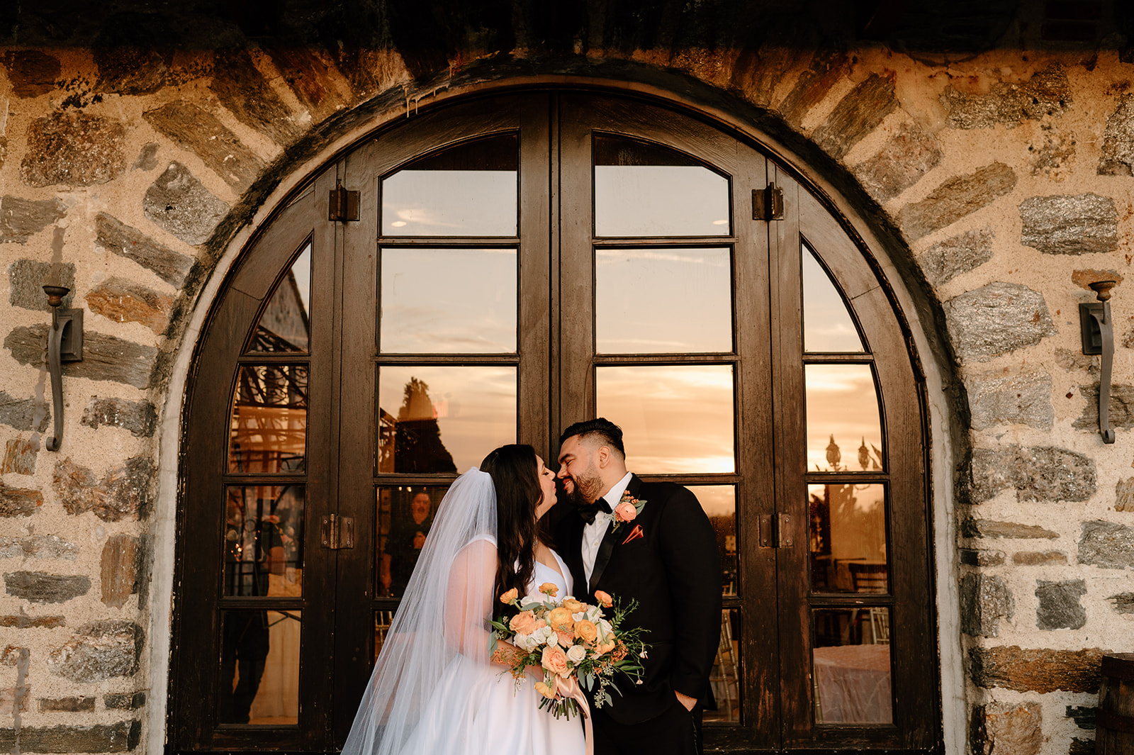 Bride and groom smiling at each other during wedding portraits at Douglaston Manor in NY